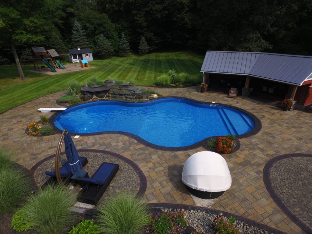 Freeform pool with waterfall and cabana built by Chaffee's