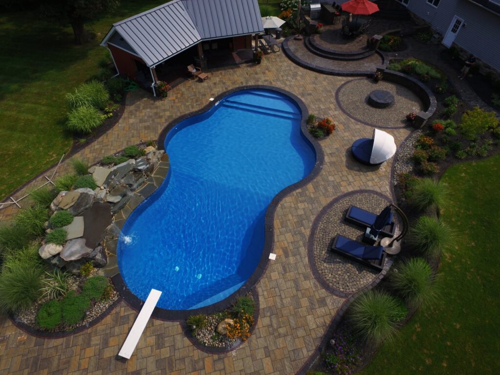 Aerial view of a freeform pool and outdoor living space by Chaffee's