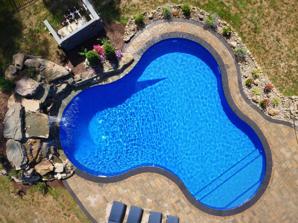 Overhead view of a freeform pool with natural rock waterfall by Chaffee's