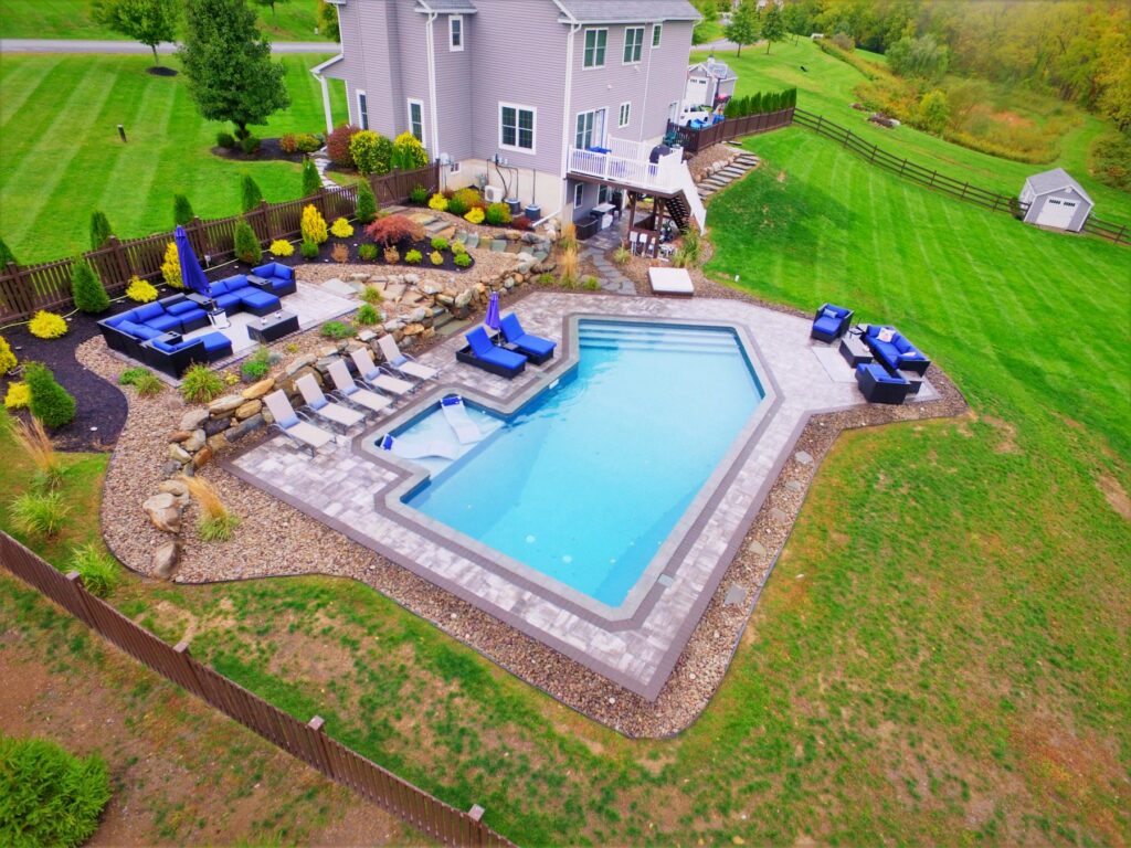 Aerial view of a geometric pool with outdoor living areas by Chaffee's