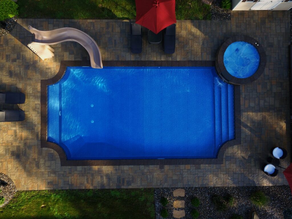 Inground pool with attached spa seen from above