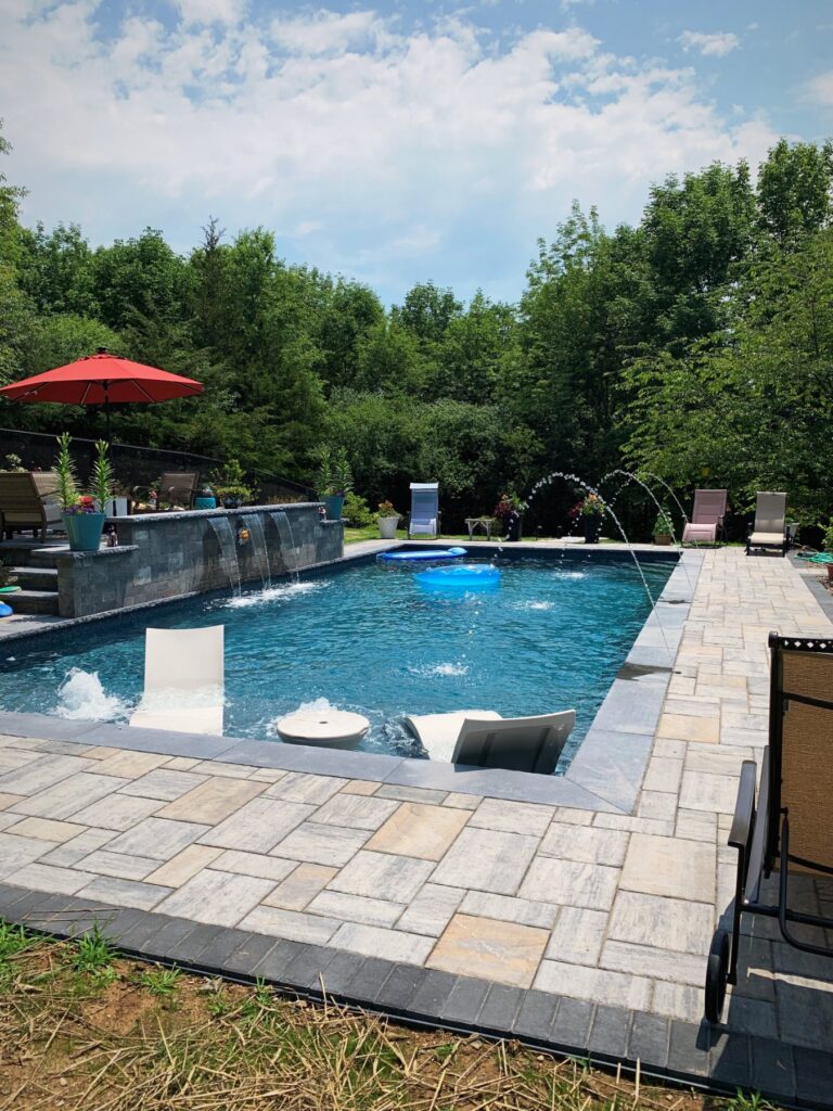 Rectangle pool with sheer descent waterfalls, deck jets and tanning ledge by Chaffee's