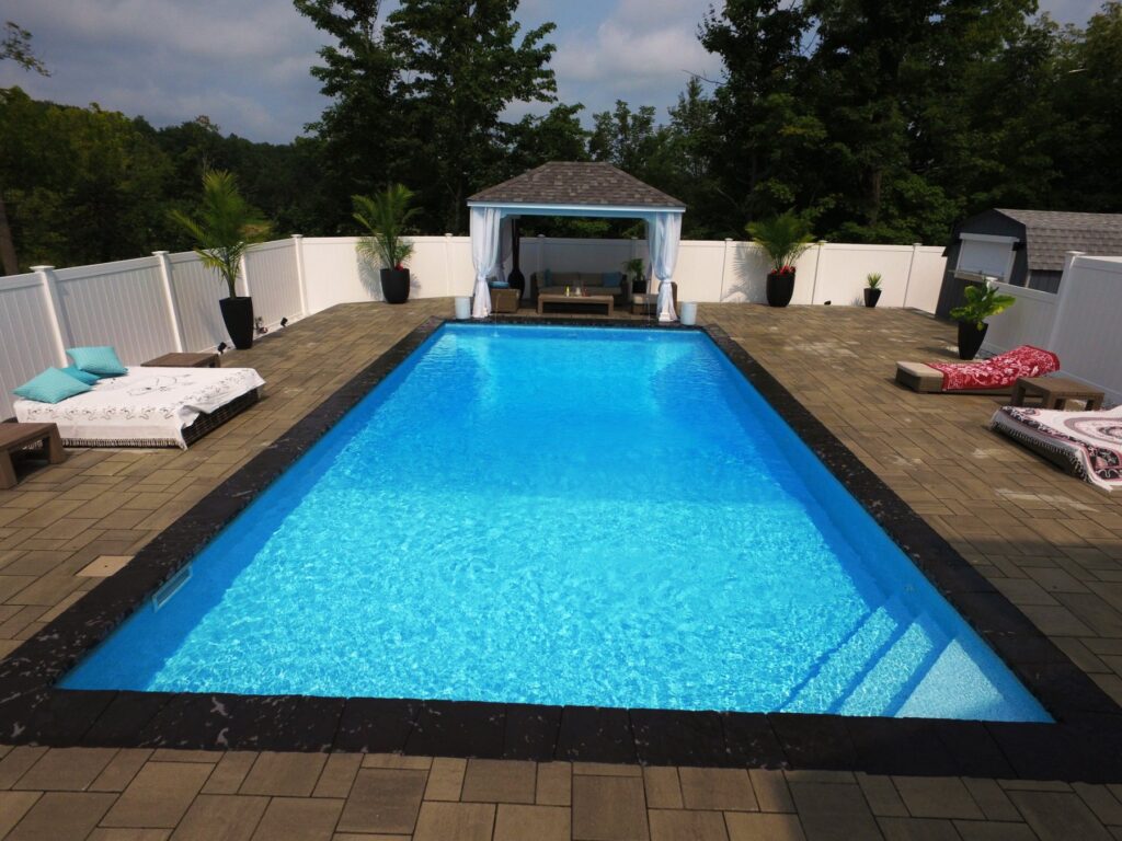 Rectangle inground pool with cabana in a Hudson Valley backyard