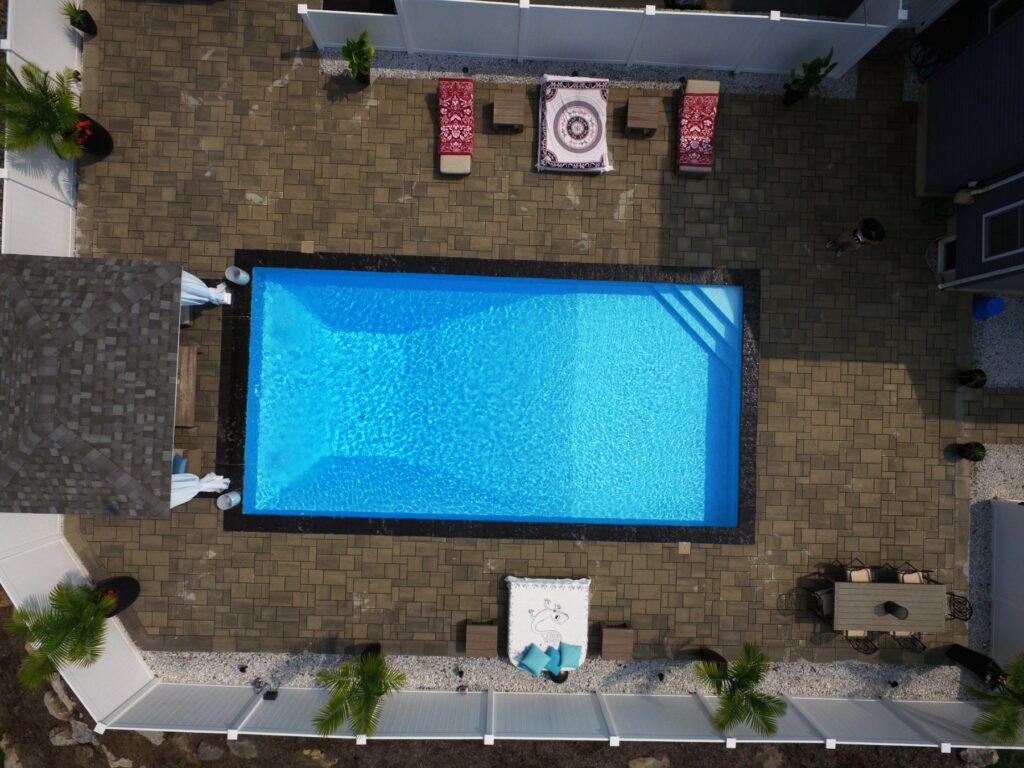Overhead view of a rectangle inground pool and paver patio by Chaffee's